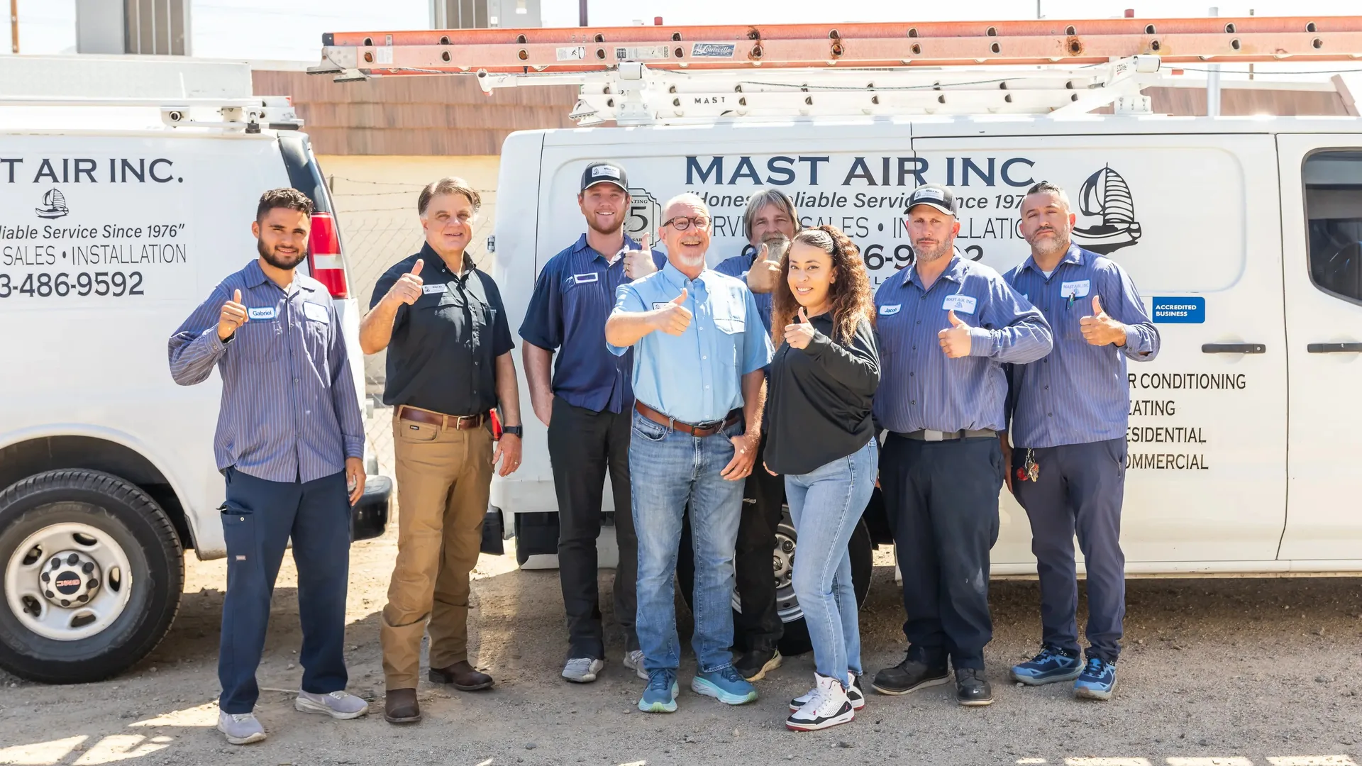 Legacy Mast Air transition photograph with branded HVAC service vans