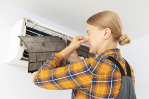 Female maister fixing dirty air conditioner in room